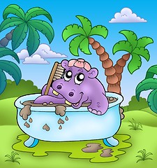 Image showing Cute hippo taking mud bath