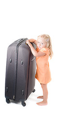 Image showing Little girl and suitcase in studio