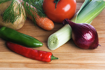 Image showing  vegetables  on a wooden kitchen board