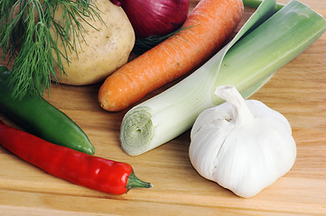 Image showing  vegetables  on a wooden kitchen board