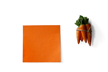 Image showing orange sticky note and carrots bunch isolated on white