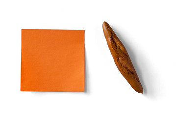 Image showing orange sticky note and figure of french loaf isolated on white