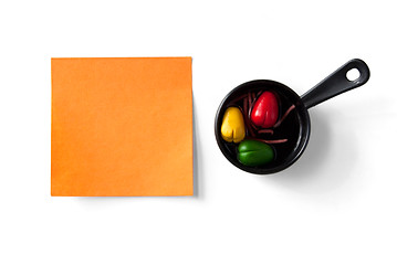 Image showing orange sticky note and figure of frying pan isolated on white