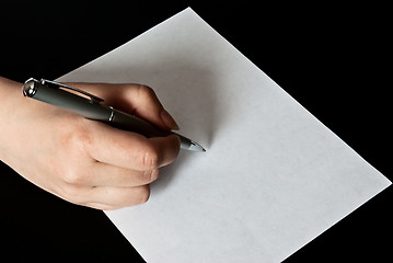 Image showing woman writing on a blank sheet of paper