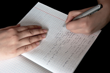 Image showing woman writing in a school notebook