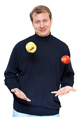 Image showing Man in dark cloth juggle apple