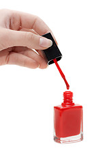 Image showing Hand with tassel and red varnish for nail