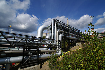 Image showing industrial pipelines on pipe-bridge against blue sky