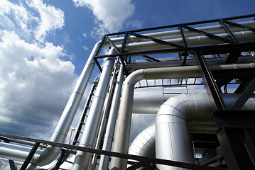 Image showing industrial pipelines on pipe-bridge against blue sky