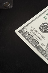 Image showing One Hundred dollar note on black  fur  wallet
