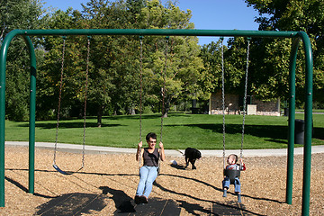 Image showing Mother and Little Boy Swinging