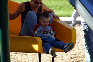 Image showing Little Boy Sliding with his Mother