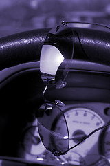 Image showing Sunglasses on the steering wheel