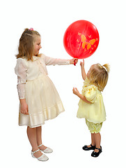 Image showing Two girls play with balloons.