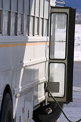 Image showing White School Bus Pumping Gas