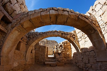 Image showing Converging ancient stone arches 