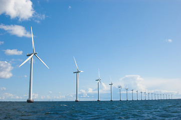 Image showing Windmills in a row on sunny weather, front