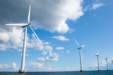 Image showing Four windmills in a row on sunny day