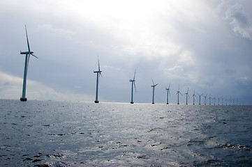 Image showing Windmills in a row on cloudy weather