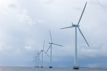 Image showing Windmills on cloudy weather,  back shot