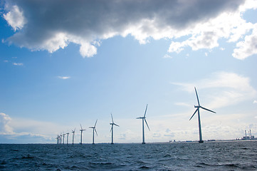 Image showing Windmills in a row on sunny weather,  back shot