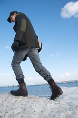 Image showing man walking on snow