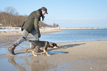 Image showing master with dog at the beach
