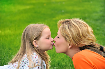 Image showing Mother is kissing her daughter