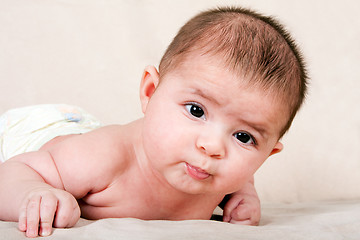 Image showing Infant laying on belly