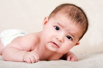 Image showing Baby laying on belly