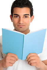 Image showing Man looking up from an open book