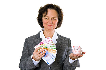 Image showing Woman with piggy bank
