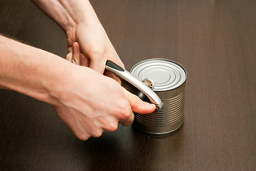 Image showing Using can-opener