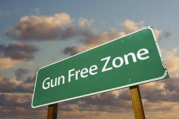 Image showing Gun Free Zone Green Road Sign and Clouds