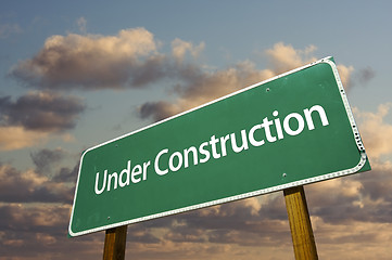 Image showing Under Construction Green Road Sign Over Clouds