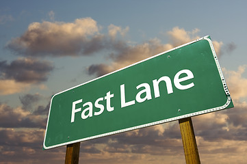 Image showing Fast Lane Green Road Sign Over Clouds