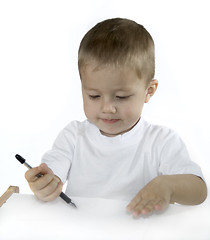 Image showing small boy is drawing isolated on white