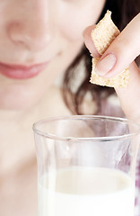 Image showing Young people eating milk with cereals