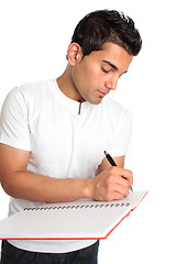 Image showing Man or student writes in a notebook