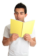 Image showing Man reading from a book