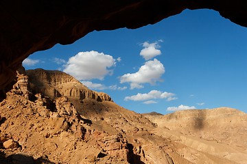 Image showing Rocky desert landscape through the cave entrance 