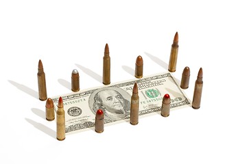 Image showing One hundred dollar bill fenced by cartridges isolated 