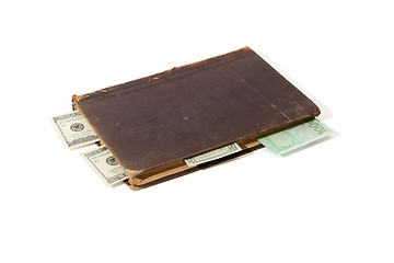 Image showing Old book with banknote bookmarks isolated 