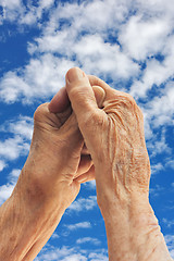 Image showing Senior woman's hands over sky