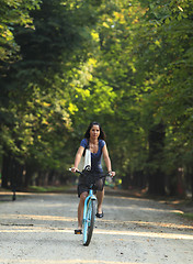 Image showing Woman riding a bicycle