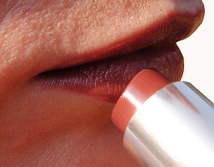 Image showing Woman Applying Lipstick