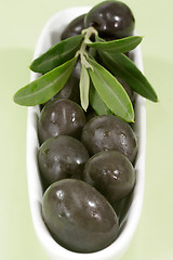 Image showing Black olives with leaves