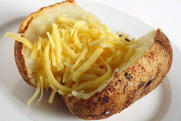 Image showing Baked russet potato with cheddar cheese