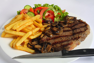 Image showing Ribeye steak dinner with knife