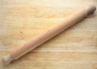 Image showing Rolling pin on wooden board